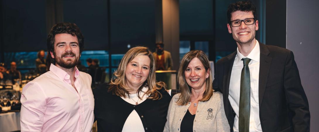 Aidan, Mandy, Mandy and Daniel pose for a photo and all smile at the camera.
